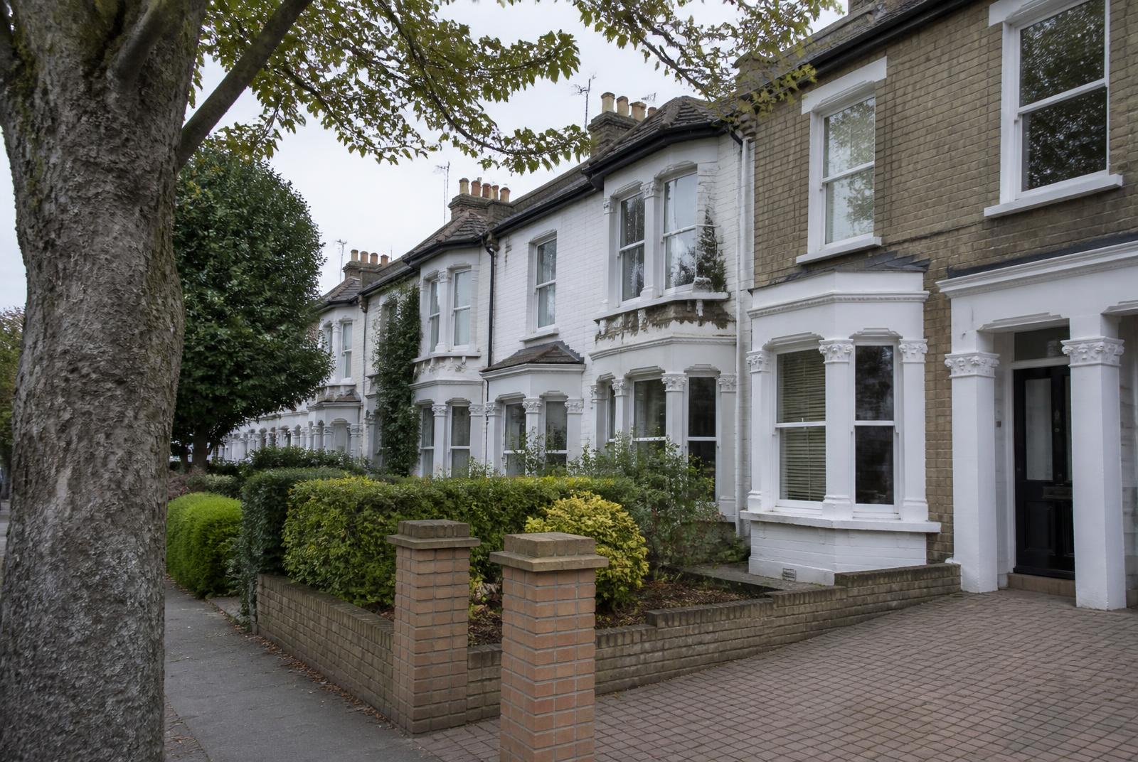 British terraced houses with block-paved driveways and small front gardens, where excavating a drain would mean lifting the paving